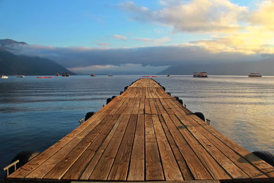 Pier over lake against sky