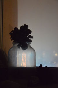 Silhouette of man sitting by window at home