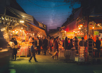 People on street in market at night