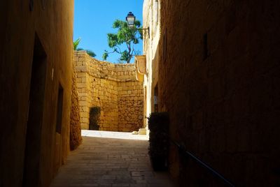 Alley amidst buildings against sky