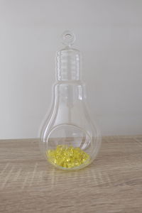 Close-up of empty glass bottle on table