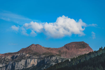 Low angle view of mountains against blue sky