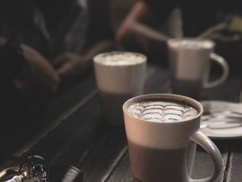 Close-up of coffee cups on table