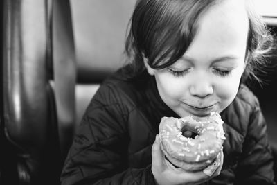 Close-up of cute boy eating donut