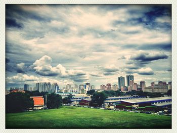 Cityscape against cloudy sky