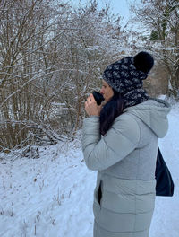 Midsection of woman on snow covered field