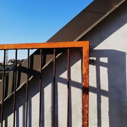 Low angle view of railing against building