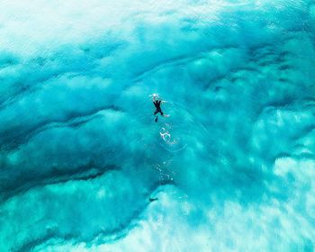 High angle view of man swimming in blue sea