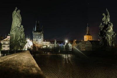 Statue of illuminated city at night