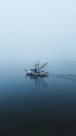 Sailboat in sea against sky