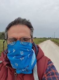 Portrait of man standing on road