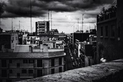 Buildings against cloudy sky