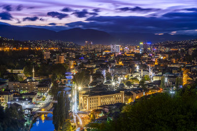 High angle view of illuminated city buildings at night