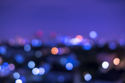 Defocused image of illuminated lights at night