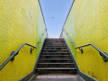 Low angle view of staircase against yellow wall