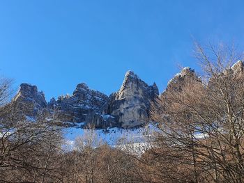Scenic view of snowcapped mountains against clear blue sky