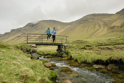 People on mountain against sky