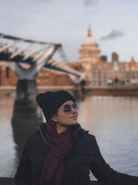 Close-up of woman looking away while standing by river