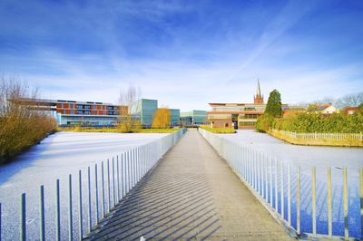 Steps leading towards built structure against blue sky