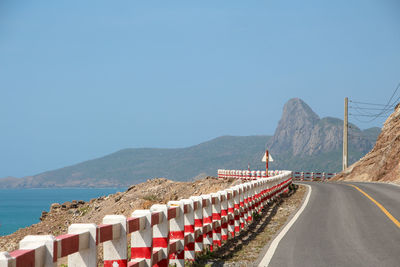 Panoramic view of road by sea against clear sky