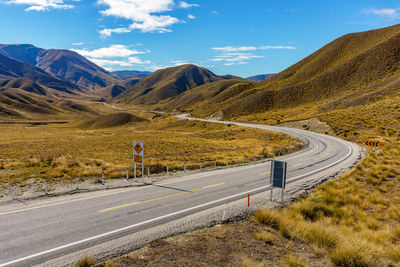 High angle view of empty road by mountains against sky