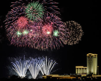Low angle view of firework display at night
