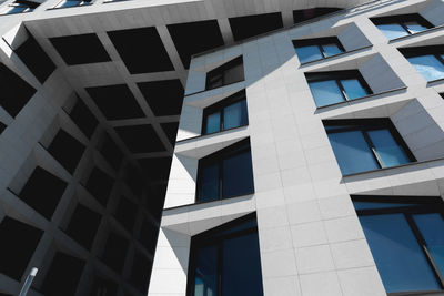Low angle view of modern building against blue sky