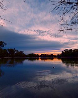 Scenic view of lake against sky at sunset