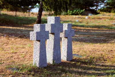 Three catholic stone crosses in german military cemetery in europe. memorial for dead soldiers