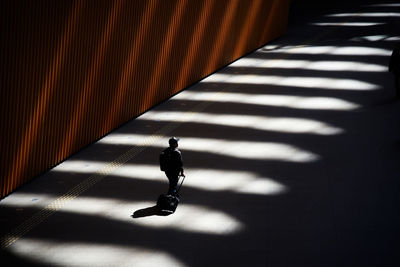 High angle view of silhouette man walking on street