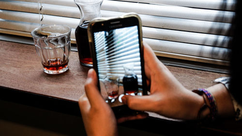 Midsection of man using mobile phone