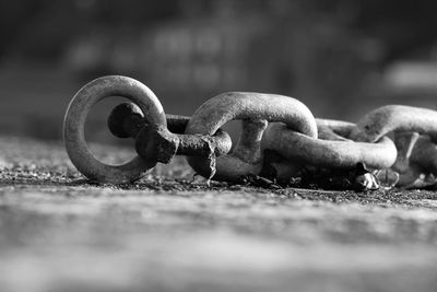 Close-up of rusty chain on field