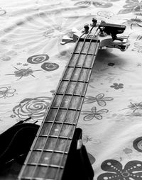 Close-up of guitar on bed