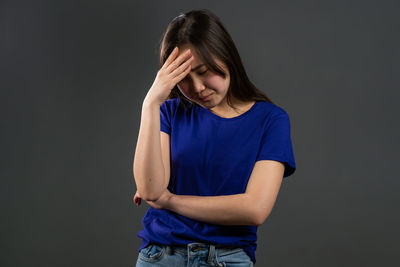 Portrait of a beautiful young woman over black background