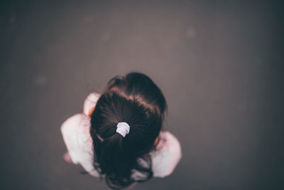 Close-up portrait of a woman over black background