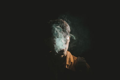 Portrait of man against black background