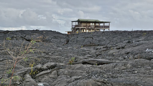 Lifeguard hut on mountain against sky