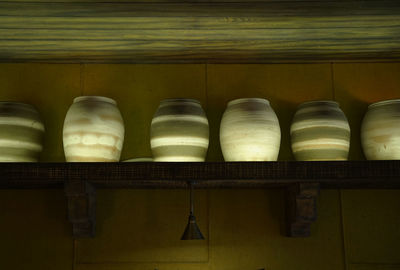 Vintage pottery barrels on a shelf as decoration in a home