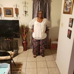 Portrait of a smiling young woman standing at home