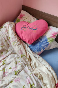 High angle view of heart shape on bed