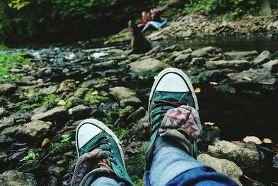 Low section of person standing on rocks