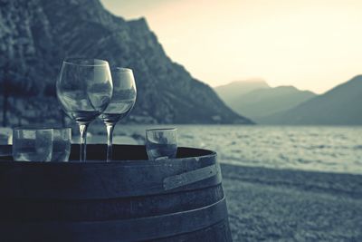Drinking glasses on wine barrel by the beach
