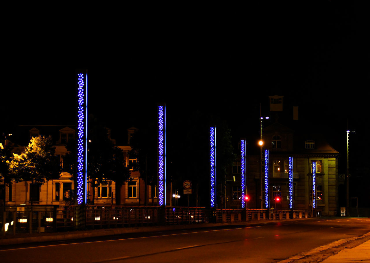 ILLUMINATED BUILDINGS AGAINST SKY AT NIGHT