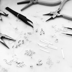 High angle view of jewelry with tools on table