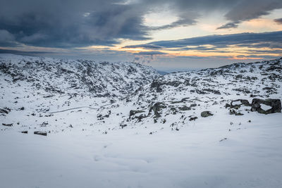 Scenic view of snow covered mountains against sky during sunset