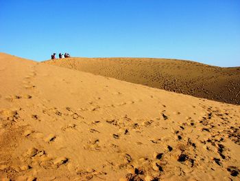 Scenic view of desert against clear sky