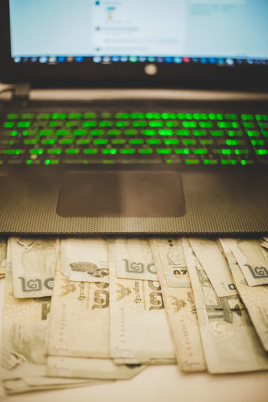 CLOSE-UP OF LAPTOP ON TABLE AT HOME