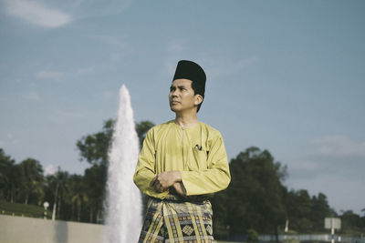 Man with traditional clothing against sky