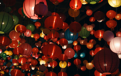 Low angle view of illuminated lanterns hanging at night