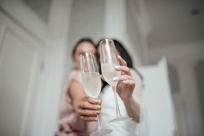 Midsection of woman drinking glass